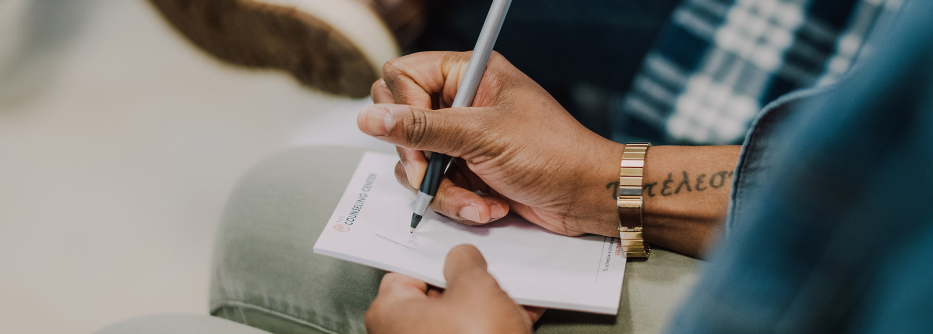 a man writing notes in a group session at Roxbury