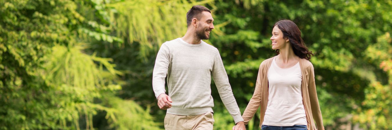  A couple walking hand in hand at a park during summer season enjoying life after rehab in Roxbury